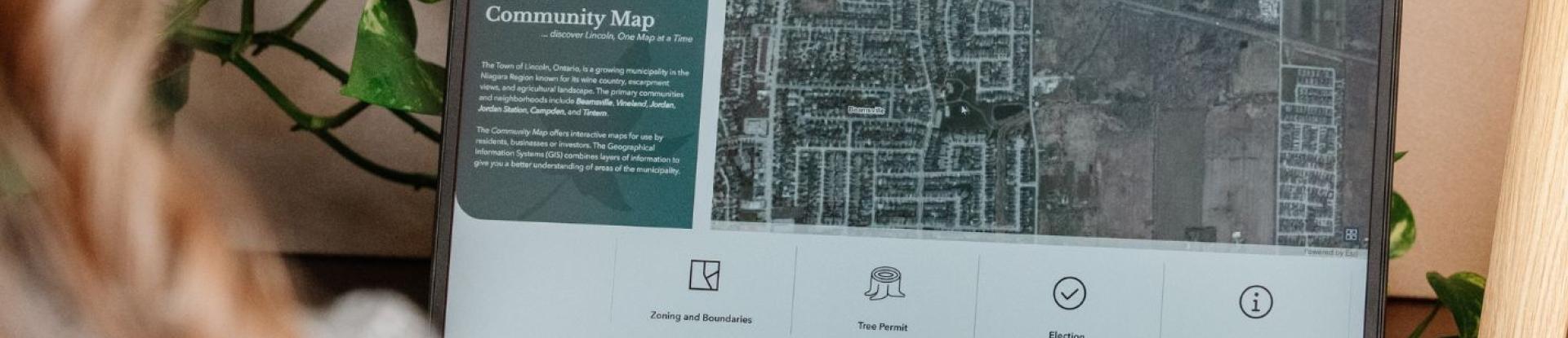 Person using the Town of Lincoln's interactive Community Map on a laptop.