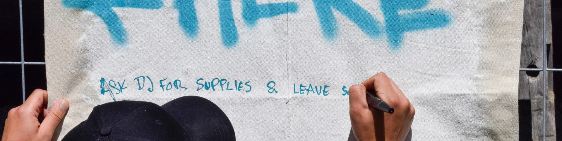 Art Lives Here spray painted on canvas