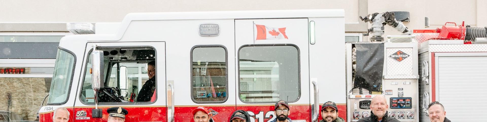 Representatives from the Town of Lincoln Council, Lincoln Fire Rescue Service and Firehouse Subs pose for a photo in front of a Firehouse Subs restaurant.