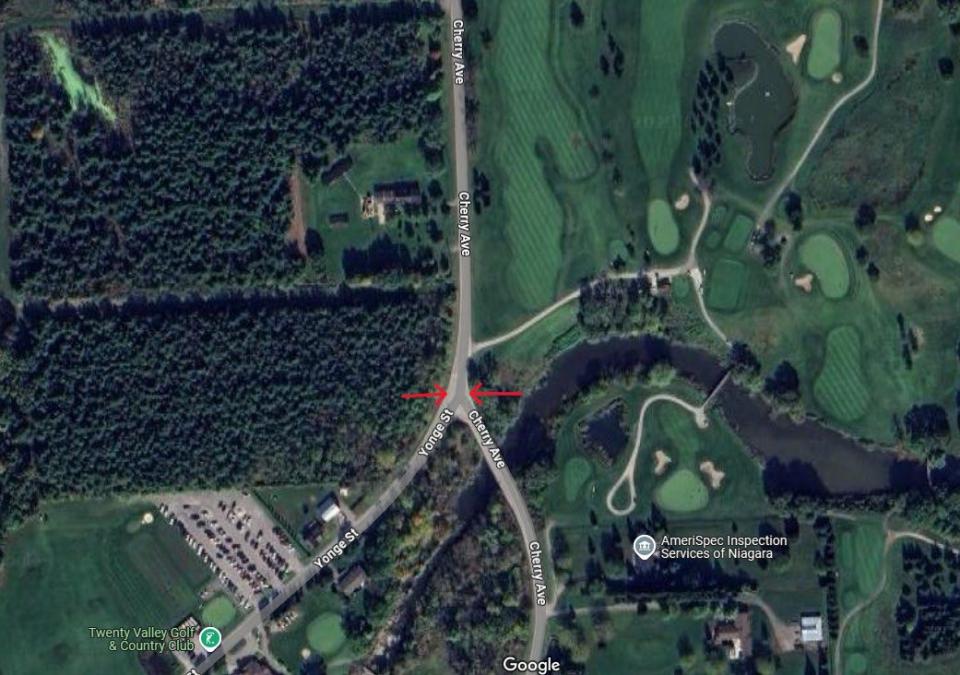 Aerial image of golf course and road indicating intersection location
