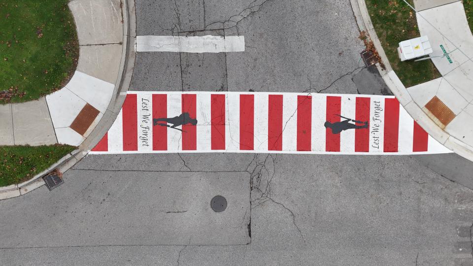 Aerial angle image of a red and white painted crosswalk.
