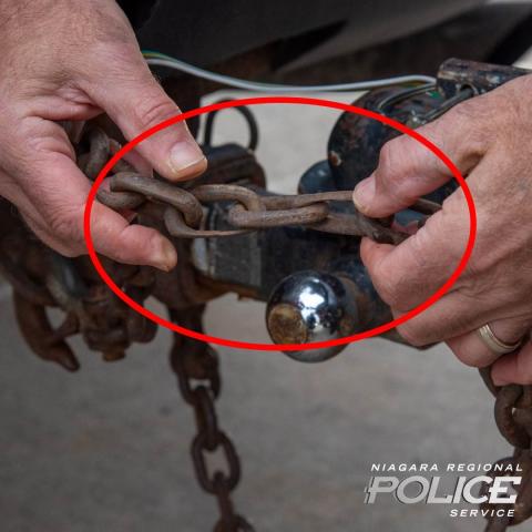 Officer inspects truck chain